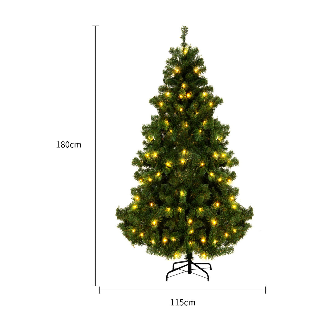 Kunstig juletre med varmhvite lys i stue
