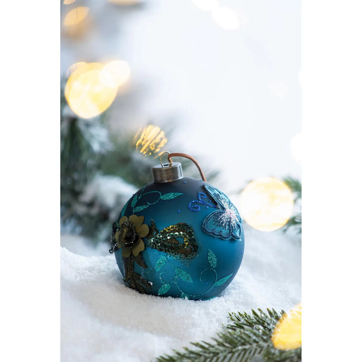 Fire blågrønne julekuler i glass med glitter