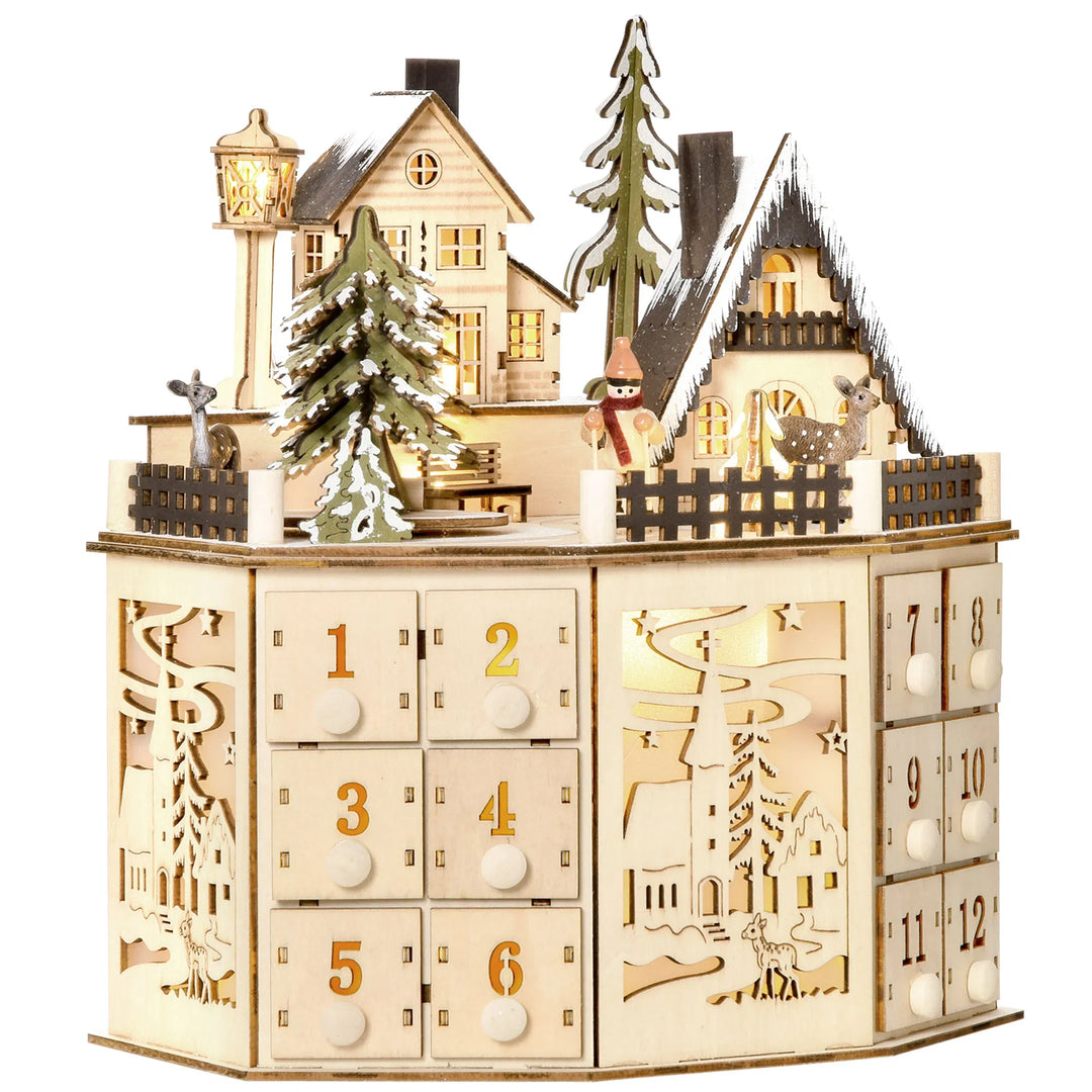 Adventskalender i tre som julelandsby med lys